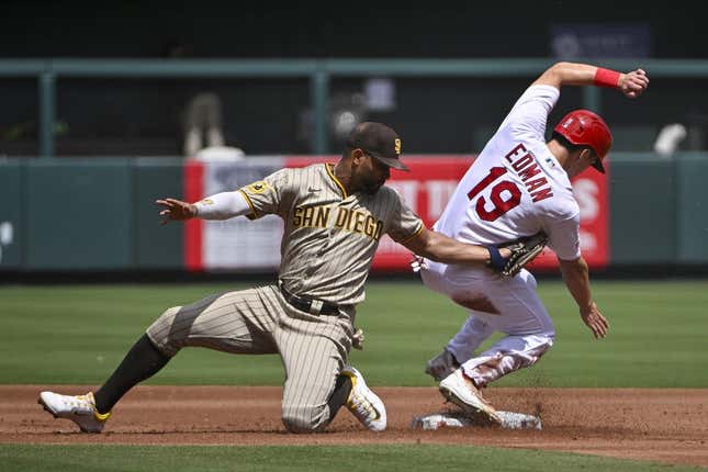 Aug 30, 2023; St. Louis, Missouri, USA;  St. Louis Cardinals center fielder Tommy Edman (19) slides safely past the tag of San Diego Padres shortstop Xander Bogaerts (2) for a stolen base during the first inning at Busch Stadium.