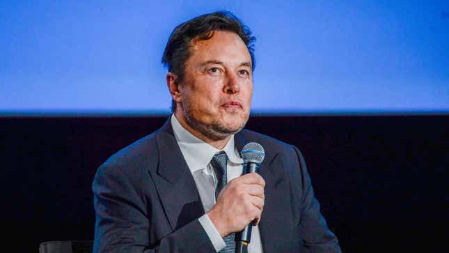 Elon Musk holding a microphone.