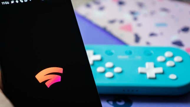 A photo of the Stadia logo with a controller in the background