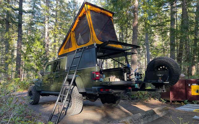 A photo of the GFC Camper set up at a campsite. 