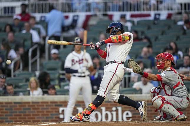 Apr 12, 2023; Cumberland, Georgia, USA; Atlanta Braves right fielder Ronald Acuna Jr. (13) singles to drive in two runs against the Cincinnati Reds during the second inning at Truist Park.