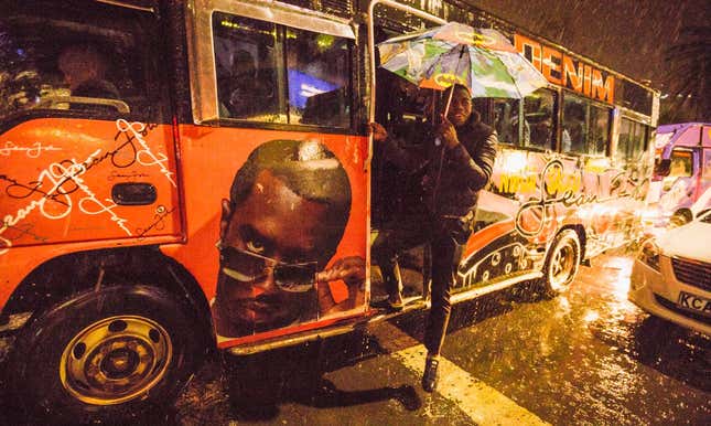 A matatu conductor calls for passengers.