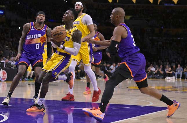 Mar 22, 2023; Los Angeles, California, USA; Los Angeles Lakers guard Dennis Schroder (17) drives past Phoenix Suns guard Chris Paul (3) in the first half at Crypto.com Arena.