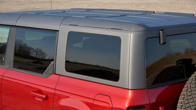 The Carbonite Gray molded-in-color hardtop, mounted on a red four-door Bronco.