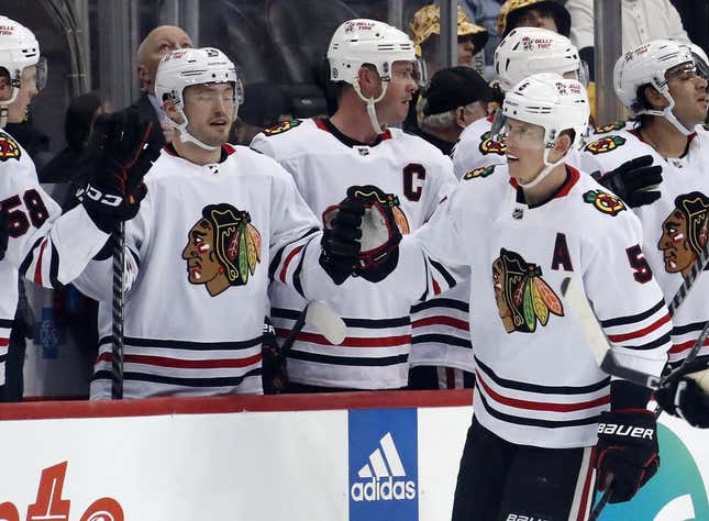 Apr 11, 2023; Pittsburgh, Pennsylvania, USA; Chicago Blackhawks defenseman Connor Murphy (5) celebrates his goal with the Chicago bench against the Pittsburgh Penguins during the second period at PPG Paints Arena.