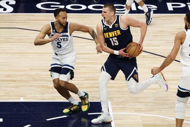 Apr 23, 2023; Minneapolis, Minnesota, USA; Denver Nuggets center Nikola Jokic (15) drives to the basket while Minnesota Timberwolves forward Kyle Anderson (5) defends during the first quarter of game four of the 2023 NBA Playoffs at Target Center.