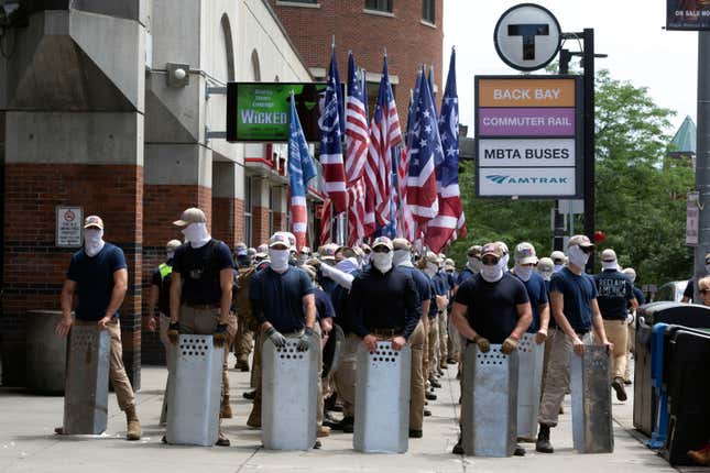 Marchers bearing insignias of the white supremacist group Patriot Front pause during a gathering on Saturday, July 2, 2022, in Boston.