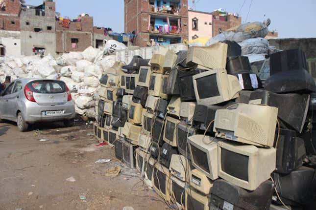 Obsolete computer electronics equipment lie stacked along the roads in Seelampur.