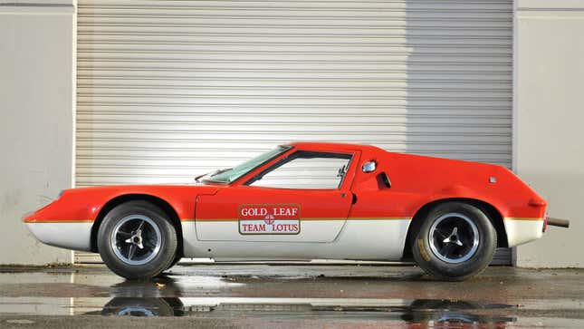 A photo of a red and white Lotus Europa sports car. 