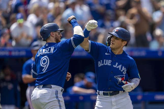 Aug 13, 2023; Toronto, Ontario, CAN; Toronto Blue Jays left fielder Daulton Varsho (25) celebrates hitting a home run against the Chicago Cubs with teammate catcher Danny Jansen (9) during the second inning at Rogers Centre.