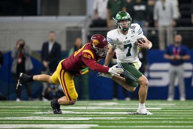 Jan 2, 2023; Arlington, Texas, USA; Tulane Green Wave quarterback Michael Pratt (7) and USC Trojans defensive lineman Nick Figueroa (99) in action during the game between the USC Trojans and the Tulane Green Wave in the 2023 Cotton Bowl at AT&amp;amp;T Stadium.