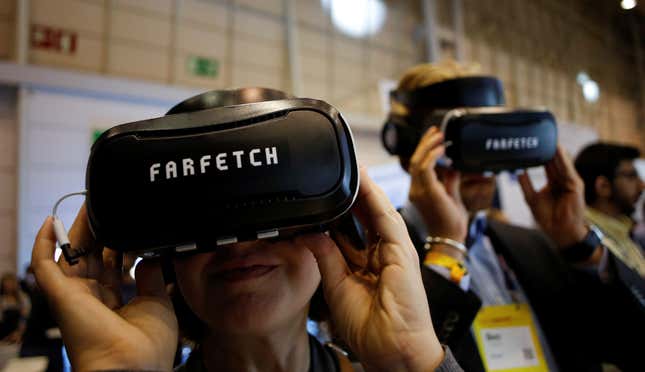 Visitors wear virtual reality glasses at the Farfetch stand during the Web Summit, Europe's biggest tech conference, in Lisbon, Portugal, November 8, 2017. REUTERS/Pedro Nunes - RC12C58A7850