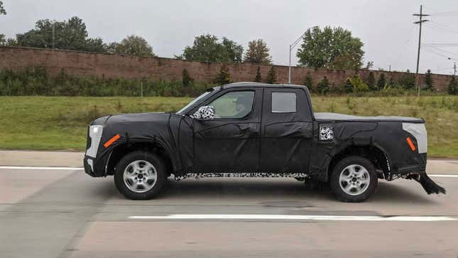 A Toyota Tacoma pickup covered in black wrappings 