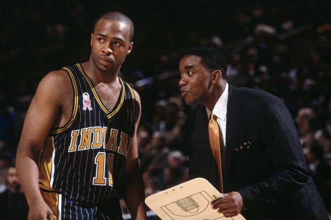 Point guard Jamaal Tinsley #11 of the Indiana Pacers talks to his head coach Isiah Thomas during the NBA game against the New York Knicks at Madison Square Garden in New York City, New York. The Knicks defeated the Pacers 101-99. 