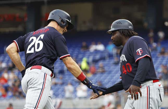 Apr 3, 2023; Miami, Florida, USA;  Minnesota Twins right fielder Max Kepler (26) is congratulated by third base coach coach Tommy Watkins (40) after his home run against the Miami Marlins during the first inning at loanDepot Park.