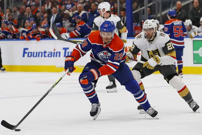 Mar 25, 2023; Edmonton, Alberta, CAN; Edmonton Oilers forward Leon Draisaitl (29) protects the puck from Vegas Golden Knights forward Michael Amadio (22) during the first period at Rogers Place.