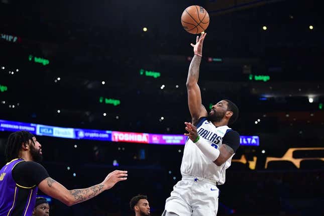 Mar 17, 2023; Los Angeles, California, USA; Dallas Mavericks guard Kyrie Irving (2) shoots against Los Angeles Lakers forward Anthony Davis (3) during the first half at Crypto.com Arena.