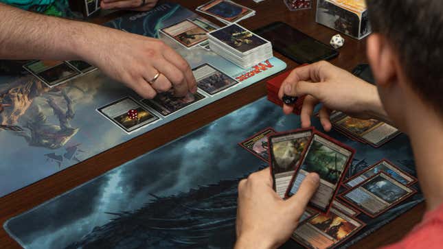 Two people play Magic: The Gathering.