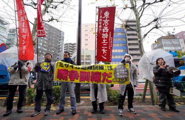 Protesters shout slogans outside the venue of an evacuation drill simulating a North Korea ballistic missile attack in Tokyo.