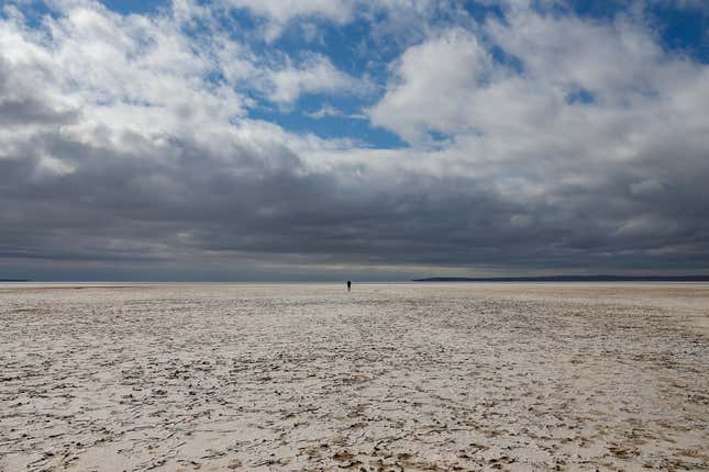 A man walks along Lake Tuz in Aksaray province, Turkey, Monday, Oct. 25, 2021. 