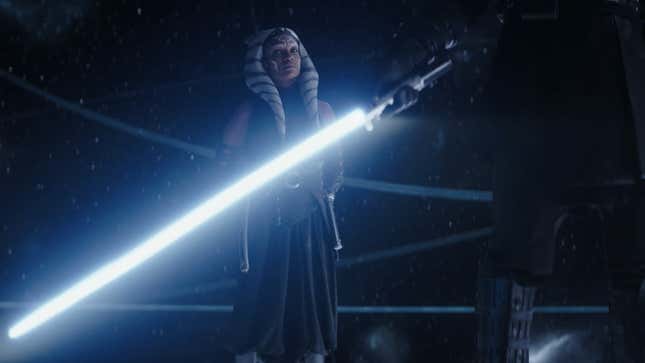 Ahsoka looks at Anakin's lightsaber.