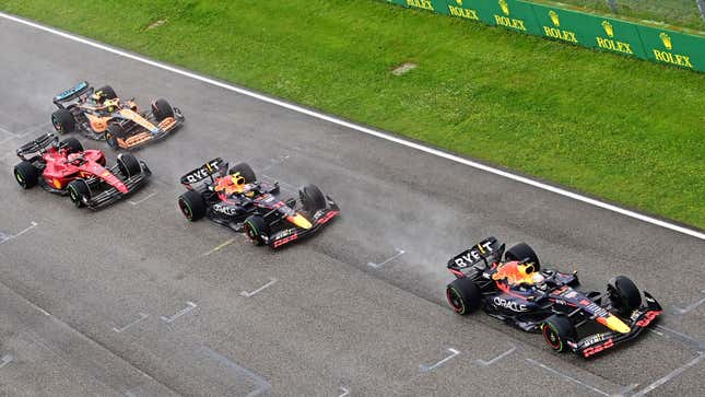 A photo of the two Red Bull F1 cars being followed by a Ferrari and McLaren. 