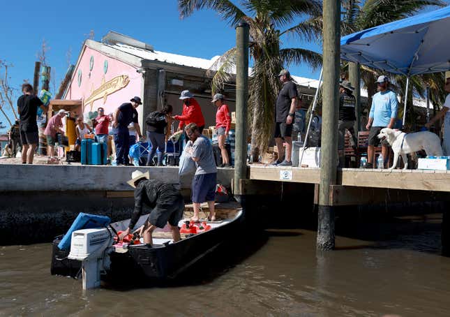 People are evacuated by boat on Pine Island on Sunday, October 2.