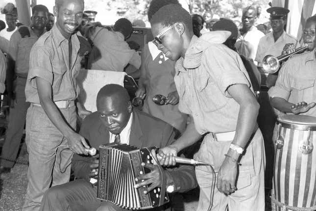 Idi Amin playing an accordion on Buvuma Island in October 1971.