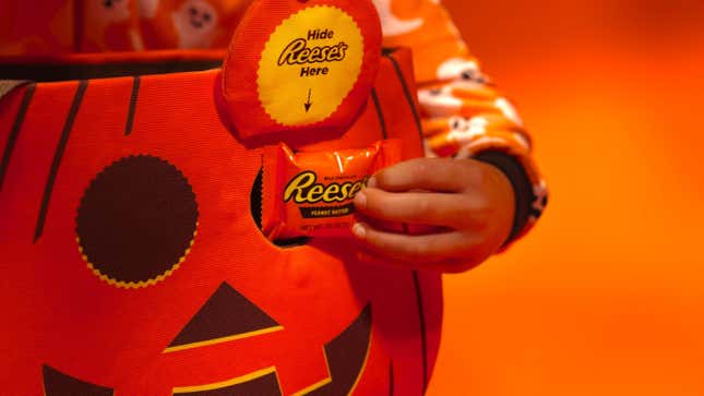 Reese's Secret Stash Trick-or-Treat bag with peanut butter cup being slipped into eye hole