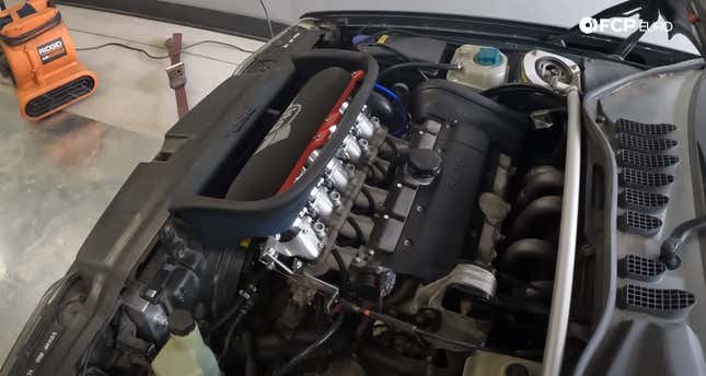Underhood view of a Volvo 850 retrofitted with individual throttle bodies.