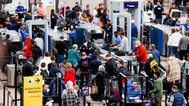 Travelers pass through a TSA security checkpoint during a winter storm at Denver International Airport on February 22, 2023 in Denver, Colorado. 