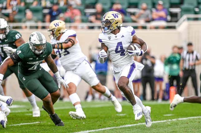 Washington&#39;s Germie Bernard, right, runs for a touchdown against Michigan State during the first quarter on Saturday, Sept. 16, 2023, at Spartan Stadium in East Lansing.