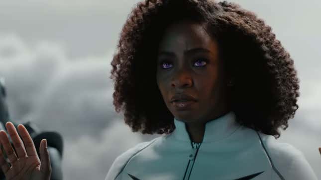 Monica Rambeau's eyes turn electric blue as she raises her hands in surrender.