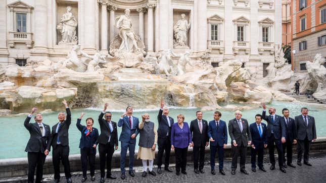 World leaders throw a coin in the water during a visit to the Trevi fountain on the second day of the Rome G20 Summit