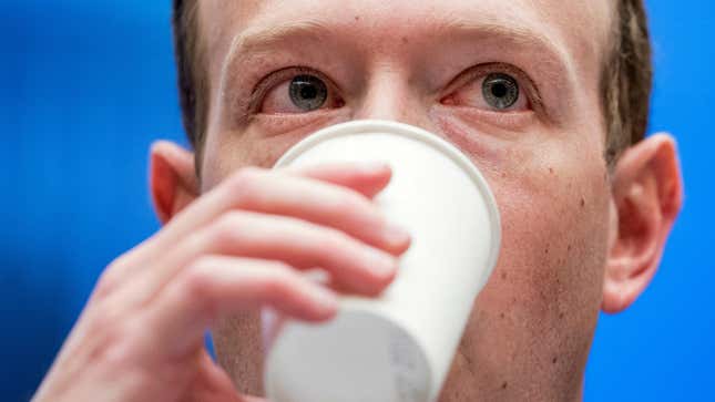 Facebook CEO Mark Zuckerberg takes a drink of water as he testifies before a House Energy and Commerce hearing on Capitol Hill in Washington. 