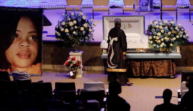 A mourner pays respects before the start of the funeral service for Atatiana Jefferson on October 24, 2019, at Concord Church in Dallas, Texas. 