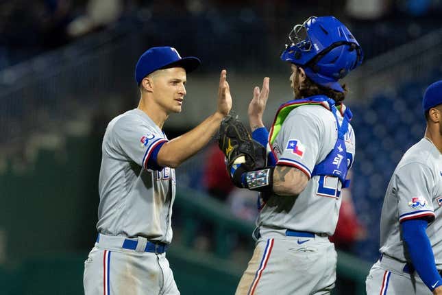 May 3, 2022; Philadelphia, Pennsylvania, USA; Texas Rangers shortstop Corey Seager (5) and catcher Jonah Heim (28) high five after a victory against the Philadelphia Phillies at Citizens Bank Park.