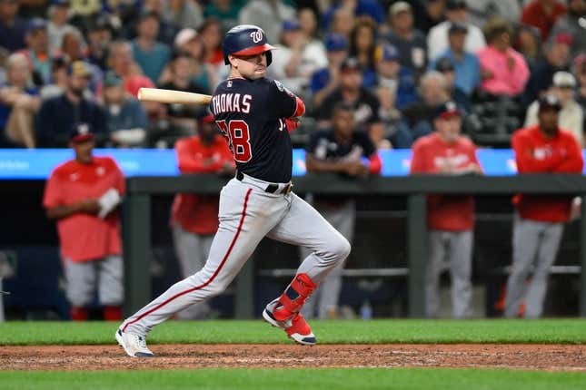 Jun 27, 2023; Seattle, Washington, USA; Washington Nationals right fielder Lane Thomas (28) hits a two run RBI double against the Seattle Mariners during the eleventh inning at T-Mobile Park.