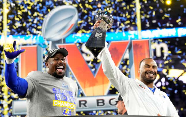Von Miller, left, of the Los Angeles Rams as in cured teammate Robert Woods holds up the Lombardi trophy after the Rams defeat the Cincinnati Bengals 23-20 in an NFL Super Bowl LVI football game at SoFi Stadium in Inglewood, on Sunday, February 13, 2022. 