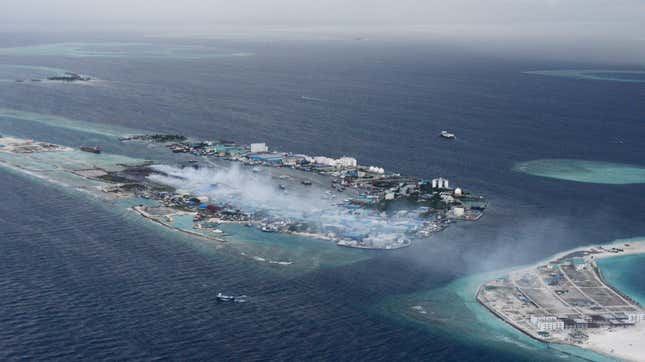 In this September 2013 photo, smoke from trash fires on Thilafushi billows out over the ocean.