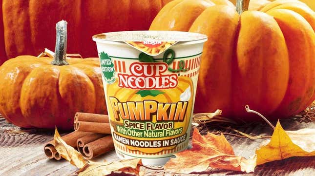 Product shot of Nissin Cup Noodles Pumpkin Spice flavor against autumnal pumpkin backdrop