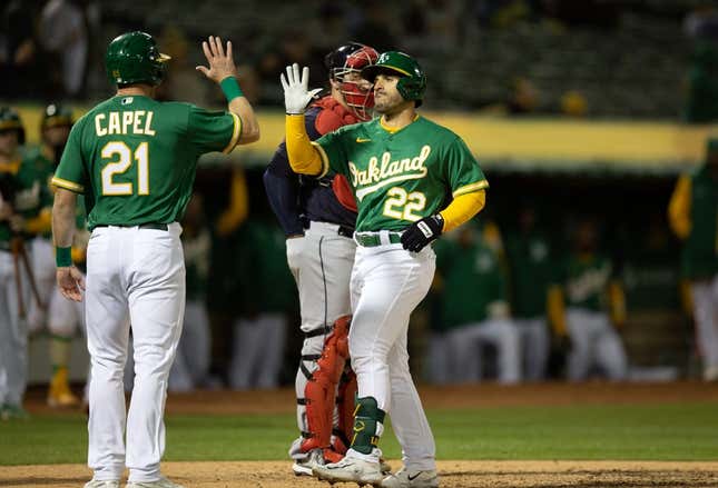 Apr 3, 2023; Oakland, California, USA; Oakland Athletics designated hitter Ram  n Laureano (22) is greeted by teammate Conner Capel (21) after hitting a two-run home run against the Cleveland Guardians during the fifth inning at RingCentral Coliseum.