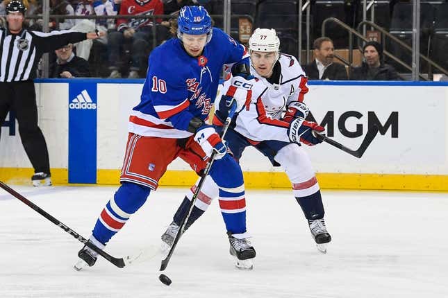 Mar 14, 2023; New York, New York, USA; New York Rangers left wing Artemi Panarin (10) skates with the puck chased by Washington Capitals right wing T.J. Oshie (77)  during the third period at Madison Square Garden.