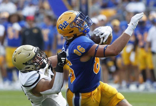 Sep 2, 2023; Pittsburgh, Pennsylvania, USA;  Pittsburgh Panthers tight end Gavin Bartholomew (86) makes a catch as Wofford Terriers linebacker David Powers (34) during the second quarter at Acrisure Stadium.