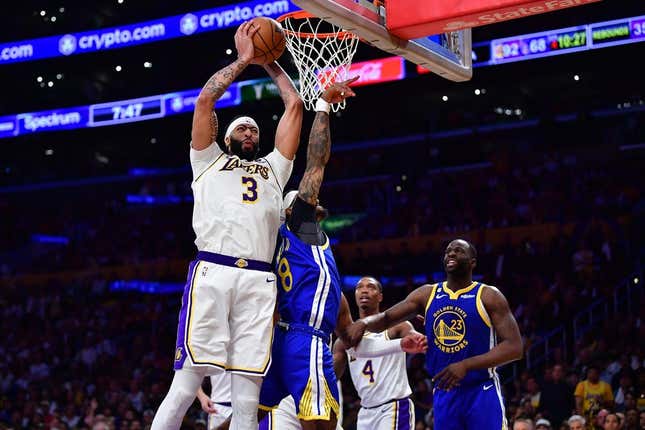 May 6, 2023; Los Angeles, California, USA; Los Angeles Lakers forward Anthony Davis (3) gets the rebound against Golden State Warriors guard Gary Payton II (8) and forward Draymond Green (23) during the second half in game three of the 2023 NBA playoffs at Crypto.com Arena.