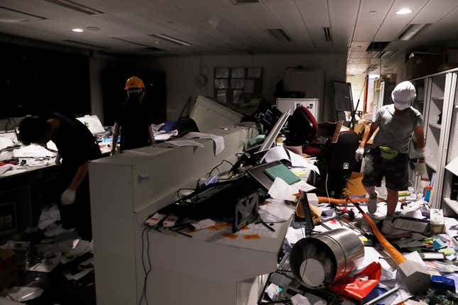 Protesters walk inside a security room after demonstrators stormed the Legislative Council building on the anniversary of Hong Kong’s handover to China, July 1, 2019.