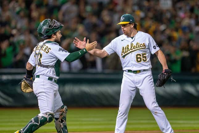Jun 13, 2023; Oakland, California, USA; Oakland Athletics relief pitcher Trevor May (65) and catcher Shea Langeliers (23) celebrate after the game against the Tampa Bay Rays at Oakland-Alameda County Coliseum.