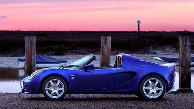 A photo of a blue Lotus Elise sports car at sunset. 