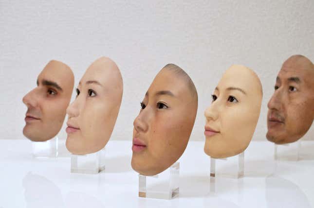 A collection of realistic masks that look like different people's faces. 