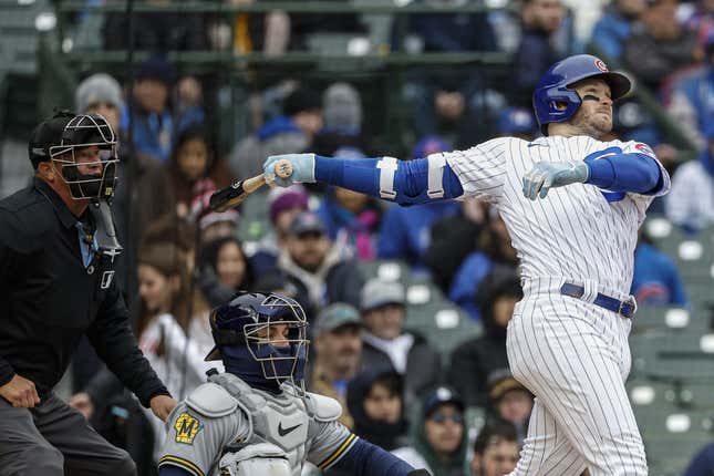 Apr 1, 2023; Chicago, Illinois, USA; Chicago Cubs left fielder Ian Happ (8) hits a solo home run against the Milwaukee Brewers during the sixth inning at Wrigley Field.